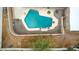 Aerial view of a private pool with surrounding patio and landscaping at 706 N Signal Butte Rd, Mesa, AZ 85207