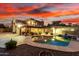 Beautiful desert backyard featuring a refreshing pool, patio, lounge chairs, and vibrant sunset at 706 N Signal Butte Rd, Mesa, AZ 85207
