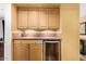 Wet bar with a wine refrigerator and wood cabinets and countertop at 706 N Signal Butte Rd, Mesa, AZ 85207
