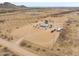 Expansive property showing house, circular driveway, outbuildings, and ample desert landscape at 7209 N Maple St, Maricopa, AZ 85139