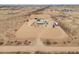 Desert property with red-lined perimeter, ample space, outbuildings, and a circular driveway at 7209 N Maple St, Maricopa, AZ 85139