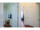 Bathroom leading to a hallway includes a convenient step-in shower and vanity at 7209 N Maple St, Maricopa, AZ 85139