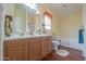 Bathroom featuring a double sink vanity, and a shower-tub combination at 7209 N Maple St, Maricopa, AZ 85139
