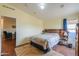 Spacious bedroom features a wood headboard, warm neutral walls, and an attached seating area at 7209 N Maple St, Maricopa, AZ 85139