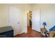Bedroom with laminate floors, neutral paint, and open door with access to other spaces at 7209 N Maple St, Maricopa, AZ 85139