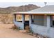 Charming desert home featuring a covered patio and drought-resistant landscaping against a backdrop of scenic mountain views at 7209 N Maple St, Maricopa, AZ 85139