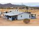 Single-story home with a covered patio, set in a desert landscape with distant mountain views at 7209 N Maple St, Maricopa, AZ 85139