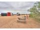 This vast lot includes desert landscaping with a picnic table and fire pit for relaxation and recreation in the serene outdoors at 7209 N Maple St, Maricopa, AZ 85139