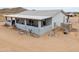 Single-story home with a covered patio, enhanced by desert landscaping and durable construction materials at 7209 N Maple St, Maricopa, AZ 85139