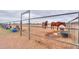 Horse corral with metal fence, horses, water trough, and a cloudy sky at 7209 N Maple St, Maricopa, AZ 85139