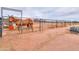 Sandy horse pen on land with straw under partly cloudy skies at the horse property at 7209 N Maple St, Maricopa, AZ 85139