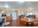 Bright kitchen with wooden cabinets, appliances, and adjacent dining area at 7209 N Maple St, Maricopa, AZ 85139