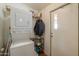 Laundry room featuring stackable washer and dryer, shelving and exterior door at 7209 N Maple St, Maricopa, AZ 85139