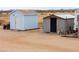 Property featuring two outbuildings, including one with a secure door and another for storage at 7209 N Maple St, Maricopa, AZ 85139