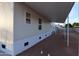 Side view of home showcasing the covered patio and low maintenance yard at 7836 E Javelina Ave, Mesa, AZ 85209