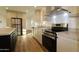 Well-lit kitchen featuring stainless steel appliances, granite countertops, and stylish cabinetry and flooring at 7836 E Javelina Ave, Mesa, AZ 85209