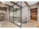 Luxurious bathroom featuring a glass enclosed shower, soaking tub, and walk-in closet at 8307 E Gary Rd, Scottsdale, AZ 85260
