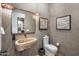 Unique powder bathroom featuring stone vessel sink, accent wall and modern fixtures at 8307 E Gary Rd, Scottsdale, AZ 85260