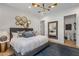 Comfortable bedroom with stylish lighting, ensuite bathroom and mirror accent wall at 8307 E Gary Rd, Scottsdale, AZ 85260