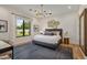 Bright bedroom with hardwood floors, modern lighting, neutral walls, large window and elegant decor at 8307 E Gary Rd, Scottsdale, AZ 85260