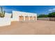 Spacious four-car garage with wooden doors and ample parking space in front of a modern building at 8307 E Gary Rd, Scottsdale, AZ 85260