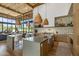 Spacious open concept kitchen featuring stone accent wall, large island with seating and wood beam ceiling at 8307 E Gary Rd, Scottsdale, AZ 85260