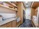 Well-organized laundry room with modern appliances, cabinets, and shelving at 8307 E Gary Rd, Scottsdale, AZ 85260