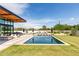 Beautiful backyard featuring a pool, lush green grass, outdoor seating and a modern home exterior at 8307 E Gary Rd, Scottsdale, AZ 85260