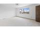 Bright bedroom with a large window overlooking the palm tree lined neighborhood at 843 W Nido Ave, Mesa, AZ 85210