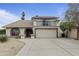 Charming two-story home featuring a balcony, arched entry, desert landscaping and a spacious driveway at 843 W Nido Ave, Mesa, AZ 85210