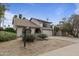 Charming two-story home featuring a balcony, arched entry, desert landscaping and a spacious driveway at 843 W Nido Ave, Mesa, AZ 85210