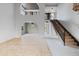 Open-concept interior showcasing architectural arches, natural lighting and stairs with wrought iron spindles at 843 W Nido Ave, Mesa, AZ 85210
