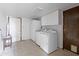 Well-lit laundry room with washer, dryer, cabinetry, and access door at 843 W Nido Ave, Mesa, AZ 85210