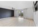 Spacious living room with new floors and a sliding glass door to the balcony at 843 W Nido Ave, Mesa, AZ 85210