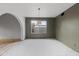 Light-filled room featuring green accent walls, a large window, hardwood floors and an arched entry at 843 W Nido Ave, Mesa, AZ 85210