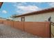 Enclosed backyard features gravel landscaping and a high brick wall for privacy at 859 S Bristol --, Mesa, AZ 85208