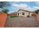 View of the backyard gravel landscaping, sparse greenery, and walled perimeter at 859 S Bristol --, Mesa, AZ 85208