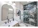 A stylish bathroom with modern fixtures, including a black-framed shower and a decorative mirror at 859 S Bristol --, Mesa, AZ 85208