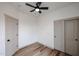 Bedroom featuring a ceiling fan, two closets, and wood-look luxury vinyl plank flooring at 859 S Bristol --, Mesa, AZ 85208