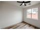 The bedroom features a ceiling fan, a window with a view, and wood-look luxury vinyl plank flooring at 859 S Bristol --, Mesa, AZ 85208