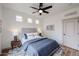This is a well-lit bedroom with a large bed, ceiling fan, and three accent windows at 859 S Bristol --, Mesa, AZ 85208