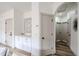 Bright hallway featuring an arched entryway, storage cabinets, and luxury vinyl plank flooring at 859 S Bristol --, Mesa, AZ 85208