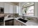 Bright kitchen featuring white cabinets, quartz countertops, and stainless steel appliances at 859 S Bristol --, Mesa, AZ 85208