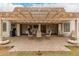 Covered back patio with neutral pavers, white support beams, and outdoor seating and dining at 923 E Aire Libre Ave, Phoenix, AZ 85022