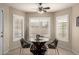 Inviting dining area with stylish black chairs, round glass table, and plantation shutters for natural light at 923 E Aire Libre Ave, Phoenix, AZ 85022