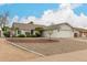 Charming single-story home with white exterior, well-maintained landscaping, and a two-car garage at 923 E Aire Libre Ave, Phoenix, AZ 85022