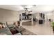 Open-concept living room showcasing a large sectional sofa, tiled floors, and access to the kitchen at 923 E Aire Libre Ave, Phoenix, AZ 85022