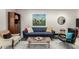 Relaxing seating area with comfortable furnishings, a modern rug, and a stylish bookshelf at 923 E Aire Libre Ave, Phoenix, AZ 85022
