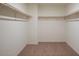 Empty walk-in closet with ample hanging space and carpeted flooring at 9823 W Agora Ln, Tolleson, AZ 85353