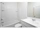 Bright bathroom with a shower and tub combination with a white tiled wall at 9840 W Agora Ln, Tolleson, AZ 85353